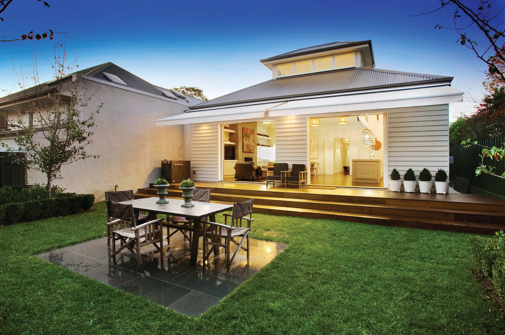 Mid-sized traditional one-storey white house exterior in Melbourne with wood siding, a gable roof and a metal roof.