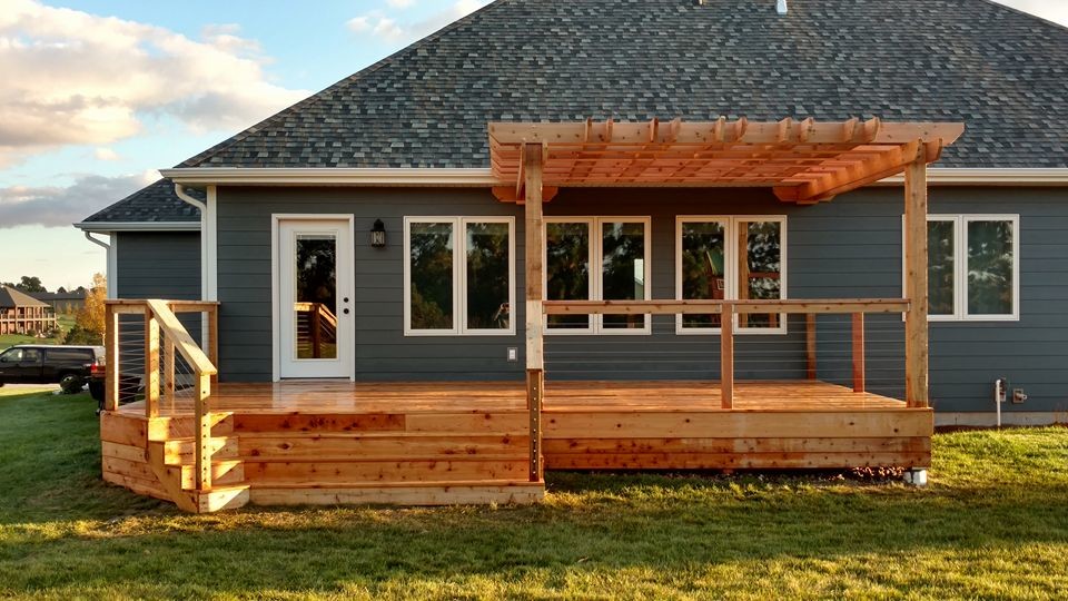 Example of a large mountain style deck design with a pergola
