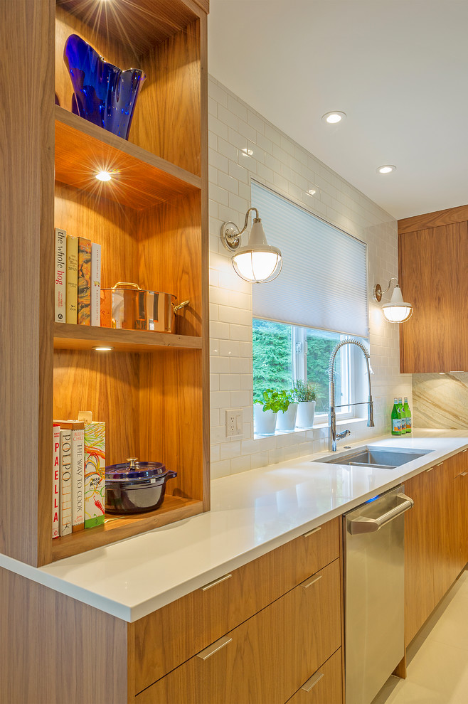 Photo of a large contemporary l-shaped eat-in kitchen in Vancouver with a single-bowl sink, flat-panel cabinets, medium wood cabinets, quartzite benchtops, beige splashback, stone slab splashback, stainless steel appliances, ceramic floors and with island.
