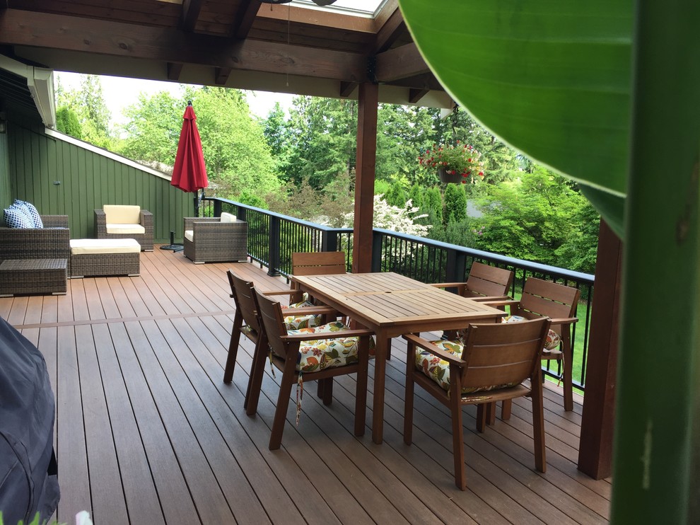 Inspiration for a large contemporary backyard deck in Seattle with a roof extension.
