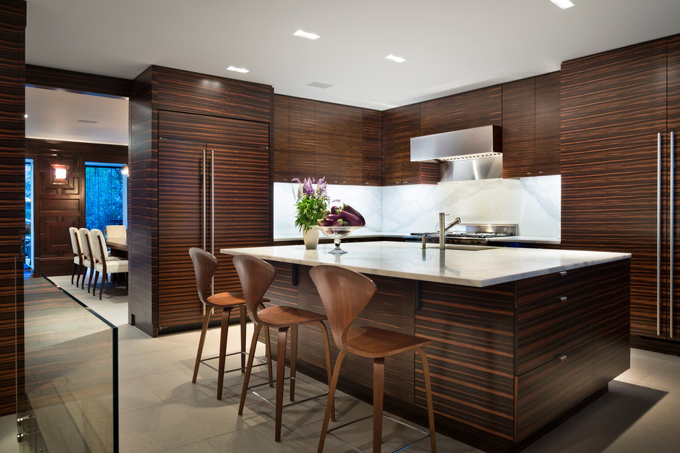 Photo of a contemporary l-shaped kitchen in New York with flat-panel cabinets, dark wood cabinets, white splashback, stone slab splashback, stainless steel appliances and with island.
