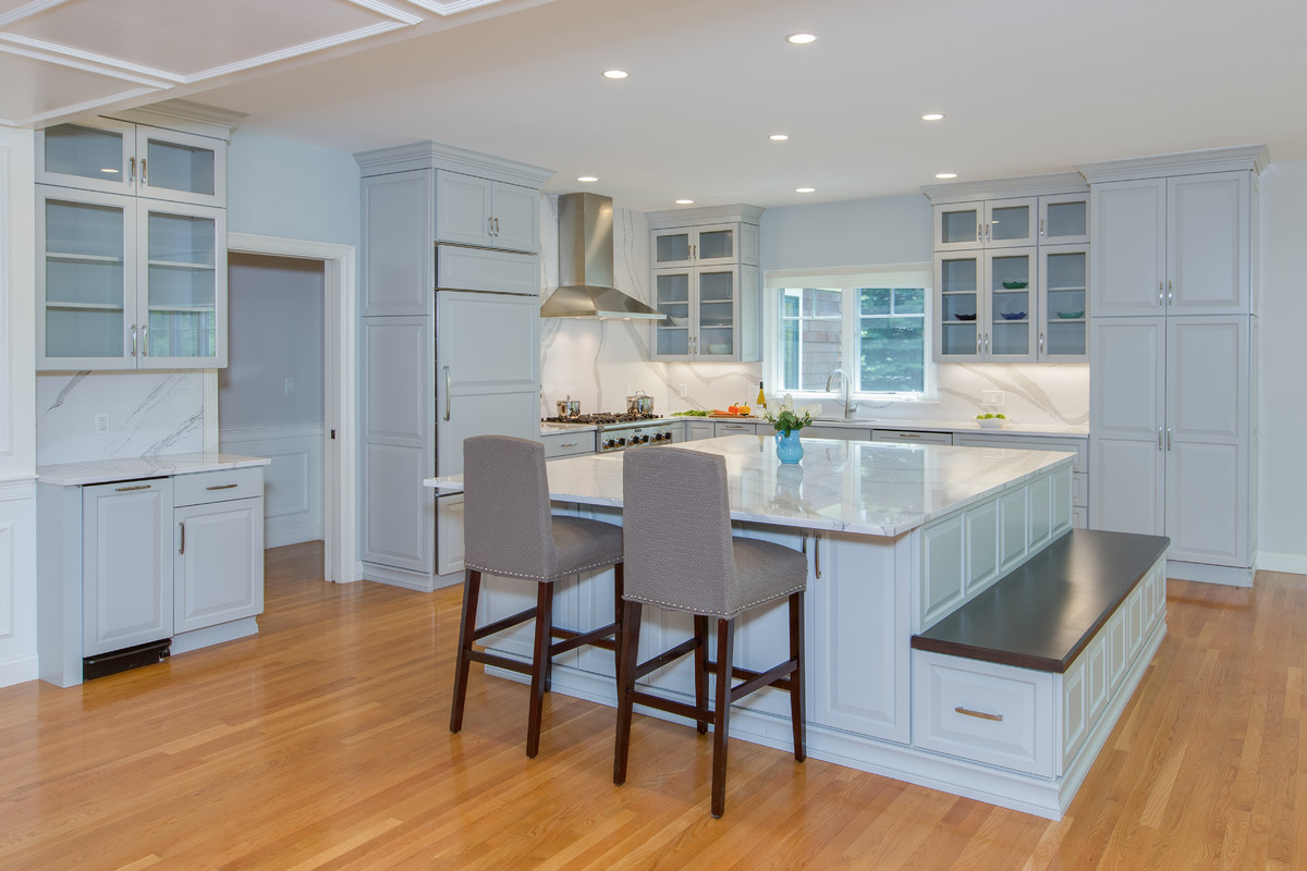 Open concept kitchen - large transitional l-shaped medium tone wood floor open concept kitchen idea in Boston with an undermount sink, raised-panel cabinets, gray cabinets, quartz countertops, stone slab backsplash, paneled appliances and an island