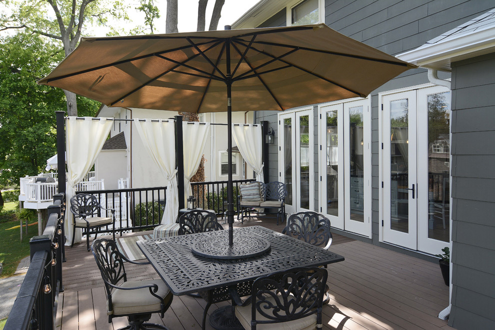 This is an example of a mid-sized beach style backyard deck in Newark with no cover.