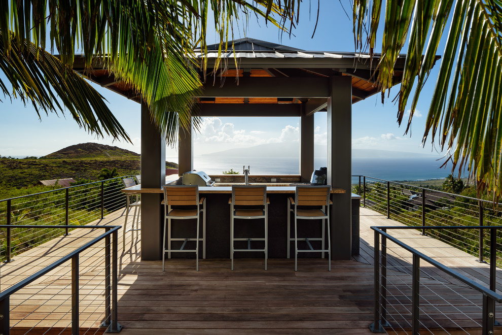 Inspiration for a tropical backyard patio in Hawaii with an outdoor kitchen, decking and a gazebo/cabana.
