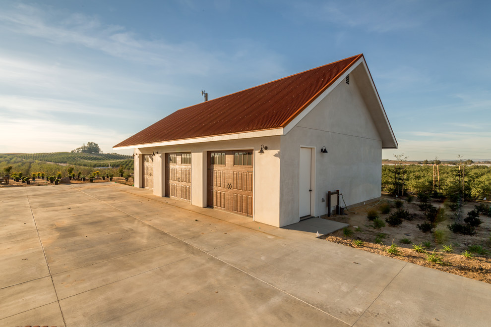 Inspiration for a large rustic detached three-car garage remodel in Sacramento