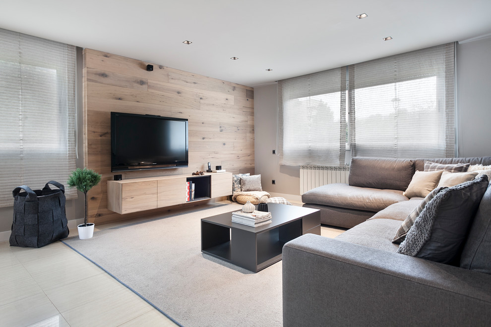 Mid-sized contemporary formal open concept living room in Barcelona with grey walls, a wall-mounted tv, beige floor and porcelain floors.