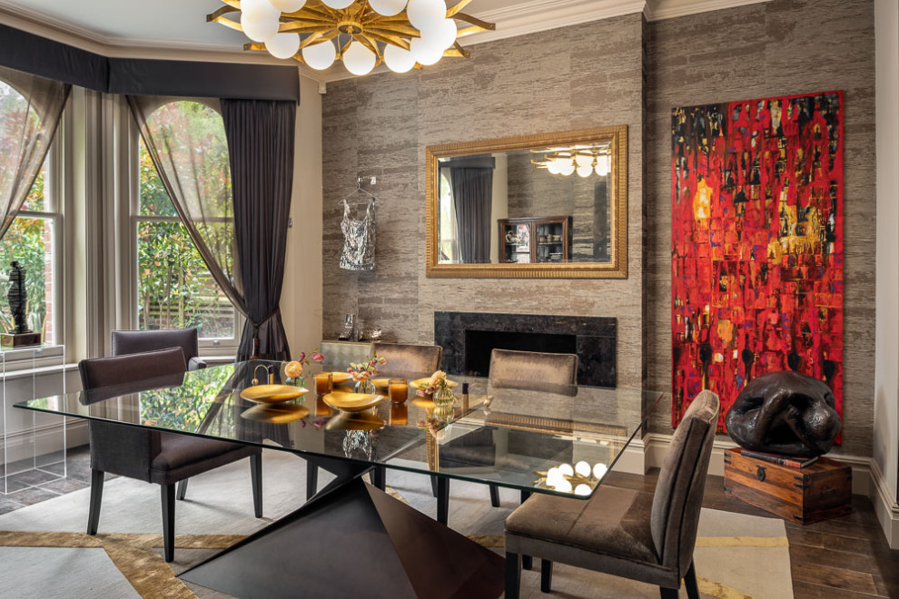Photo of a large contemporary separate dining room in London with beige walls, medium hardwood floors, a ribbon fireplace, a stone fireplace surround, brown floor and wallpaper.