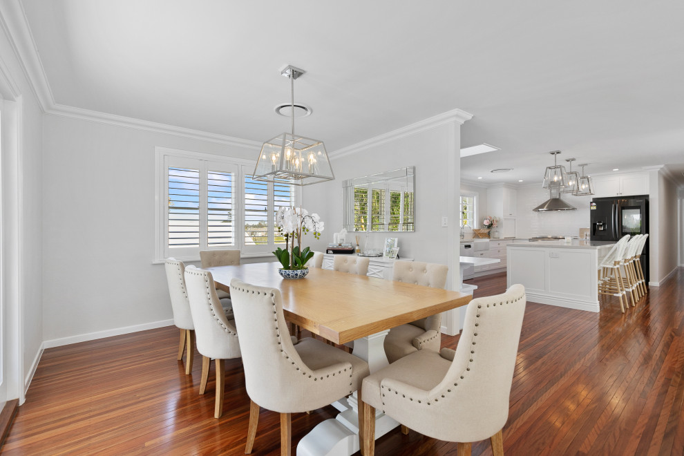 Photo of a beach style dining room in Brisbane with grey walls, medium hardwood floors and no fireplace.