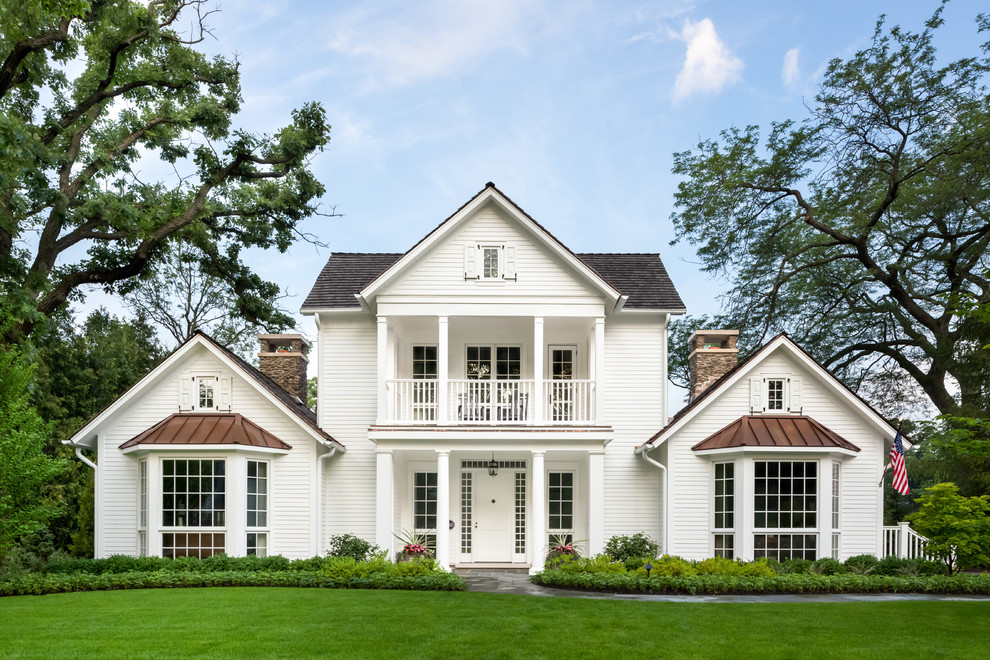 Large traditional two-storey white exterior in Chicago with wood siding.