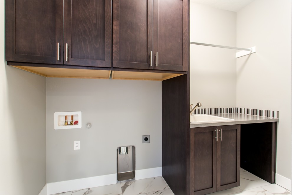 Dedicated laundry room - small transitional single-wall marble floor and white floor dedicated laundry room idea in Seattle with a drop-in sink, shaker cabinets, dark wood cabinets, quartz countertops, gray walls, a side-by-side washer/dryer and gray countertops