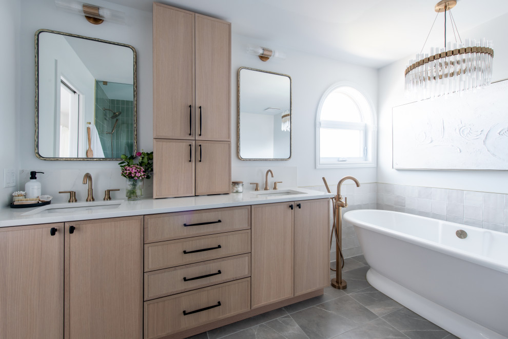 Inspiration for a mid-sized transitional u-shaped medium tone wood floor eat-in kitchen remodel with an undermount sink, shaker cabinets, white cabinets, quartz countertops, white backsplash, quartz backsplash, stainless steel appliances, a peninsula and white countertops