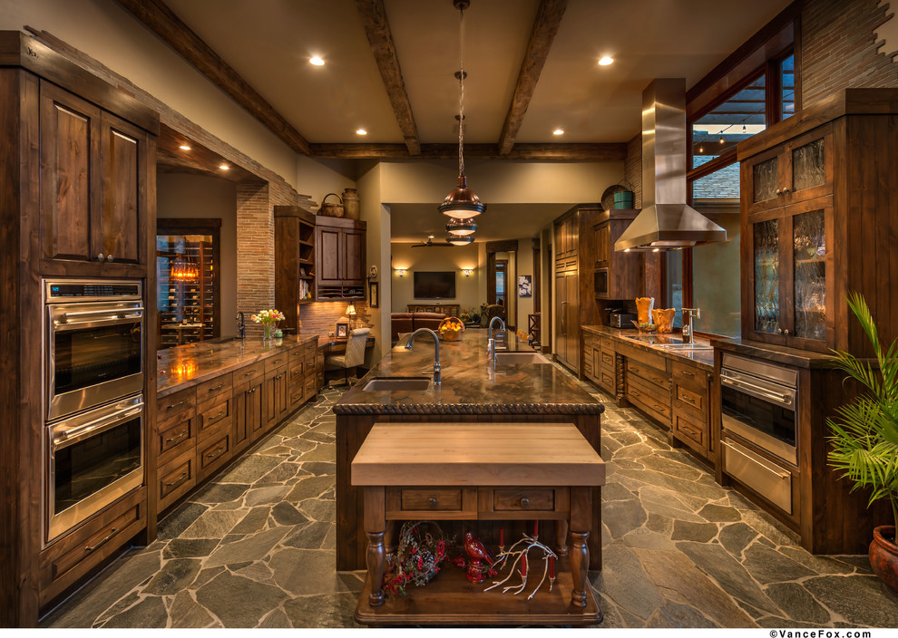 Inspiration for a large rustic u-shaped eat-in kitchen remodel with an undermount sink, distressed cabinets, marble countertops, stone tile backsplash, stainless steel appliances and an island