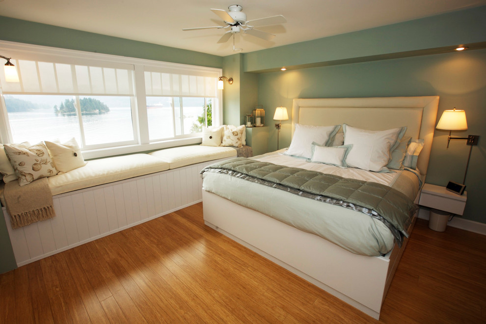 Design ideas for a large beach style master bedroom in Vancouver with blue walls and light hardwood floors.