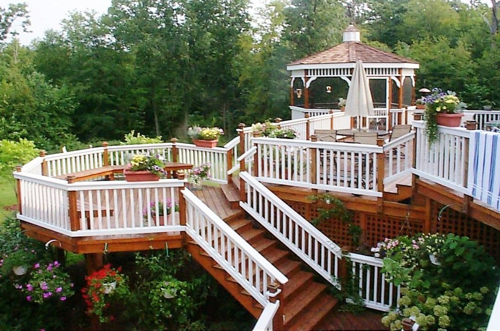 Example of a huge transitional backyard deck container garden design in New York