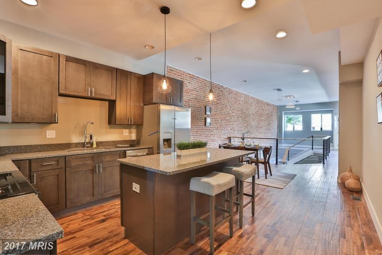 Mid-sized midcentury galley eat-in kitchen in Baltimore with an undermount sink, shaker cabinets, medium wood cabinets, granite benchtops, multi-coloured splashback, marble splashback, stainless steel appliances, medium hardwood floors, with island and brown floor.
