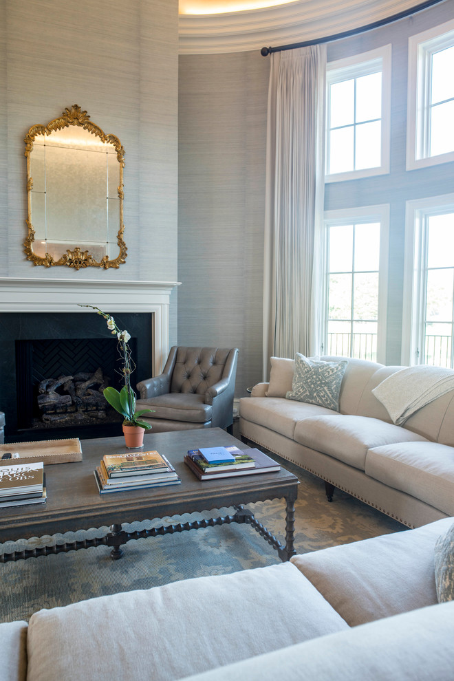 Inspiration for a large eclectic formal enclosed living room in Raleigh with blue walls, dark hardwood floors, a standard fireplace, a wood fireplace surround, a concealed tv and brown floor.