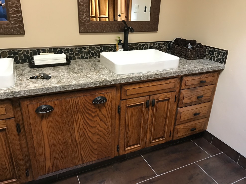 Mid-sized contemporary bathroom in Sacramento with a two-piece toilet, beige walls, porcelain floors, a trough sink, medium wood cabinets, black tile, porcelain tile and engineered quartz benchtops.