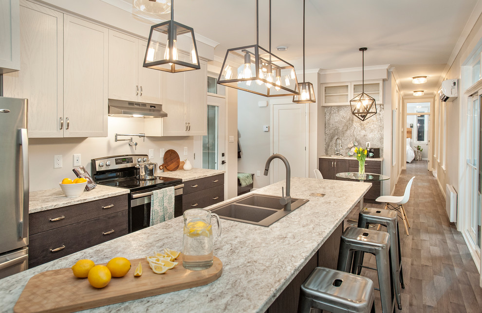 Inspiration for a small transitional galley vinyl floor and multicolored floor open concept kitchen remodel with a drop-in sink, shaker cabinets, dark wood cabinets, laminate countertops, stainless steel appliances and an island