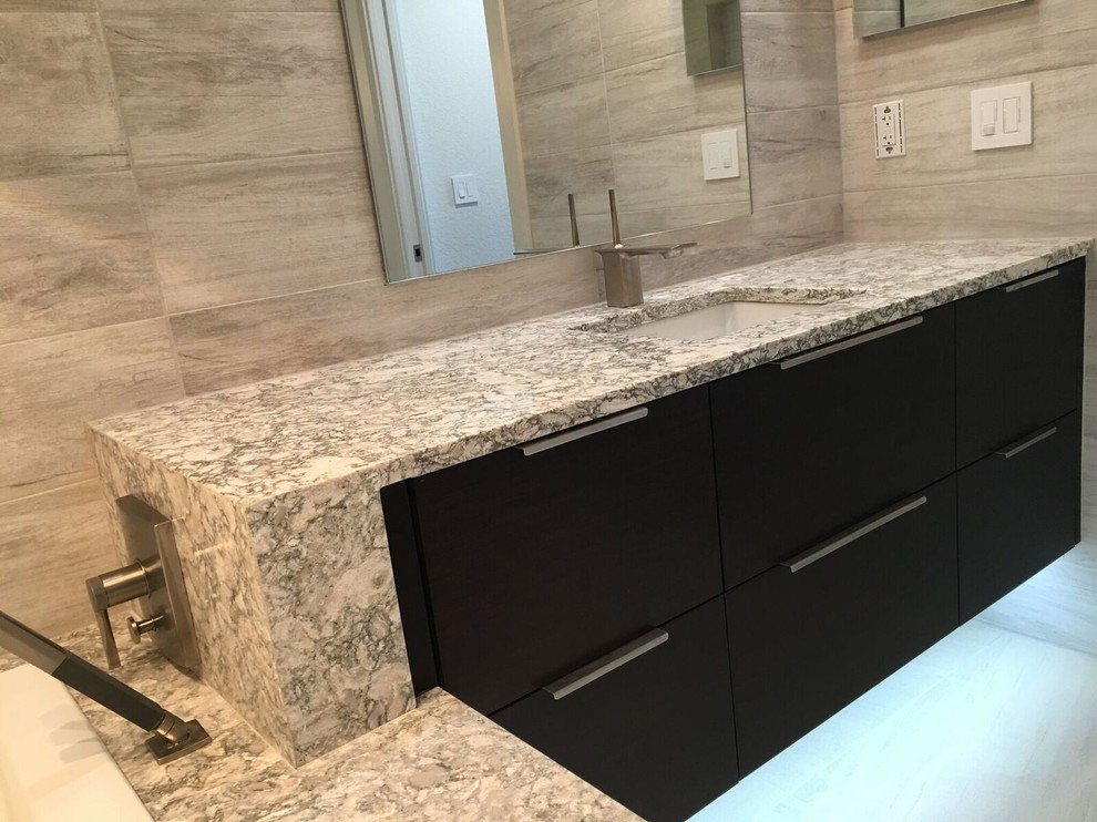 Photo of a large contemporary master bathroom in Orlando with flat-panel cabinets, dark wood cabinets, a drop-in tub, a double shower, white tile, porcelain tile, porcelain floors, an undermount sink and engineered quartz benchtops.