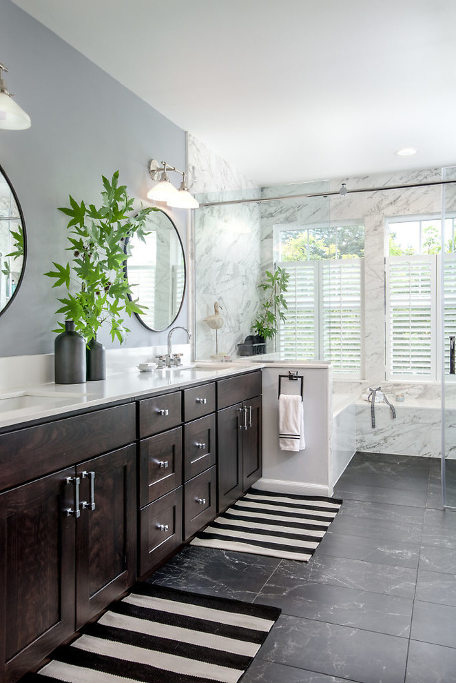 Design ideas for a large contemporary master wet room bathroom in Seattle with recessed-panel cabinets, dark wood cabinets, an alcove tub, grey walls, marble floors, an undermount sink, engineered quartz benchtops, black floor, a sliding shower screen and white benchtops.