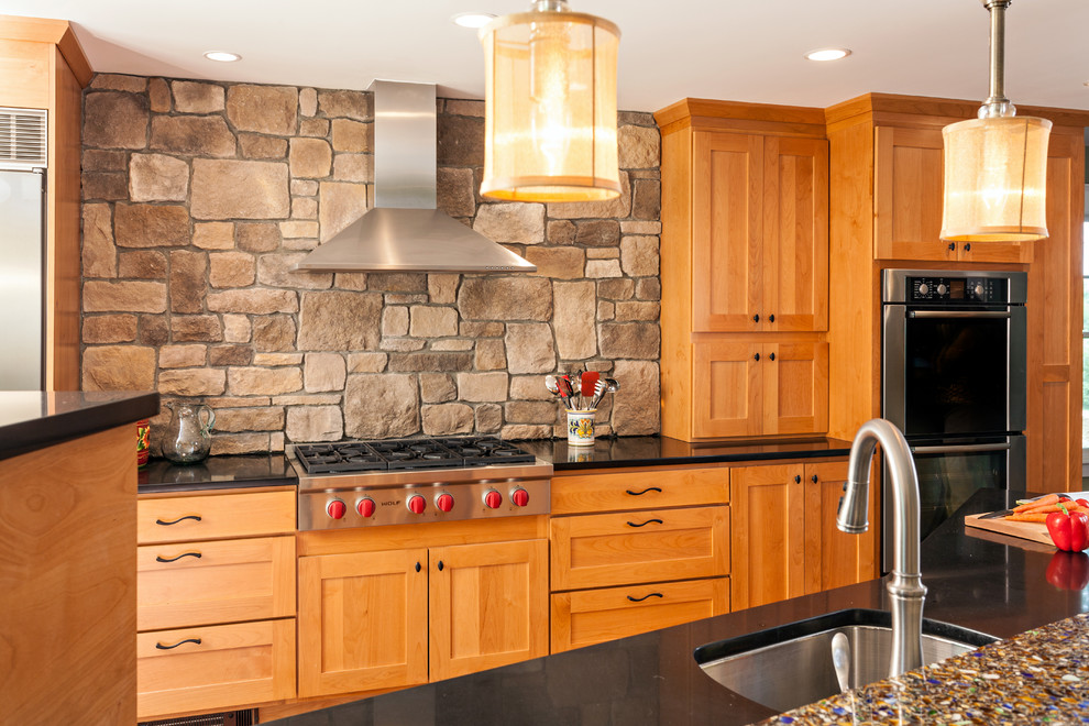 Mid-sized transitional u-shaped eat-in kitchen photo in Boston with shaker cabinets, medium tone wood cabinets, recycled glass countertops, brown backsplash, an island, an undermount sink, stone tile backsplash, stainless steel appliances and green walls