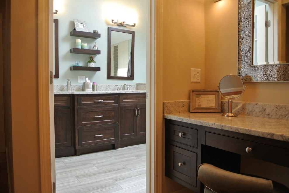 Example of a transitional master porcelain tile and beige floor alcove shower design in Boston with shaker cabinets, dark wood cabinets, a one-piece toilet, gray walls, an undermount sink, granite countertops and gray countertops