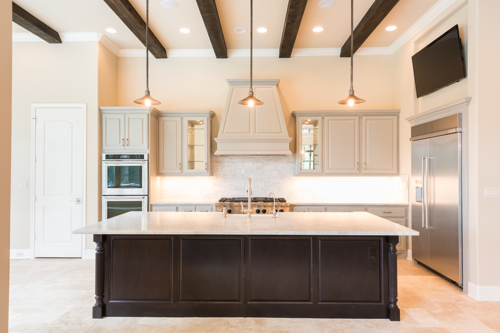 Inspiration for a huge transitional l-shaped porcelain tile and beige floor open concept kitchen remodel in Houston with a farmhouse sink, raised-panel cabinets, gray cabinets, marble countertops, gray backsplash, subway tile backsplash, stainless steel appliances, an island and white countertops