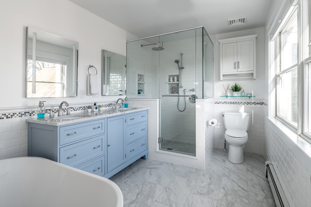 Example of a beach style white tile and subway tile gray floor and double-sink bathroom design in Portland Maine with recessed-panel cabinets, blue cabinets, white walls, an undermount sink, gray countertops and a freestanding vanity