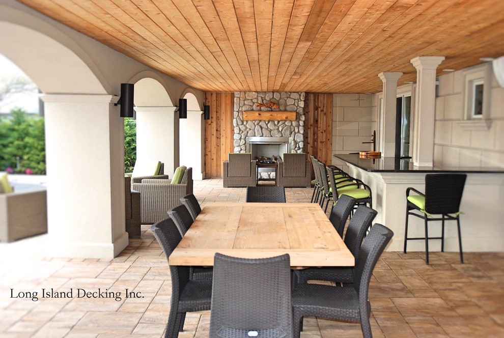 Example of a large backyard outdoor kitchen deck design in DC Metro