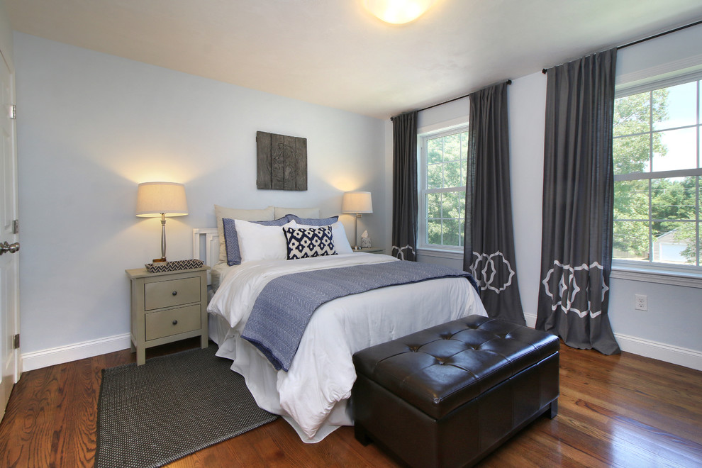 Inspiration for a mid-sized transitional guest medium tone wood floor and brown floor bedroom remodel in Portland Maine with blue walls