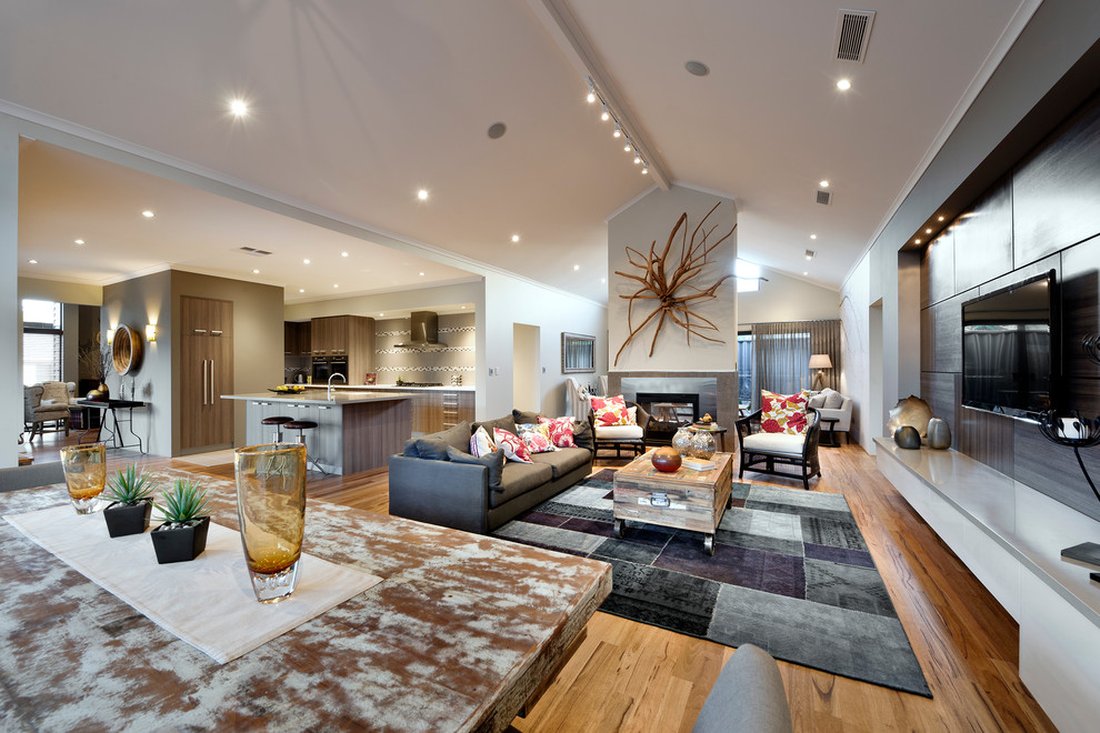 This is an example of a contemporary open concept living room in Perth with medium hardwood floors, a two-sided fireplace and a wall-mounted tv.