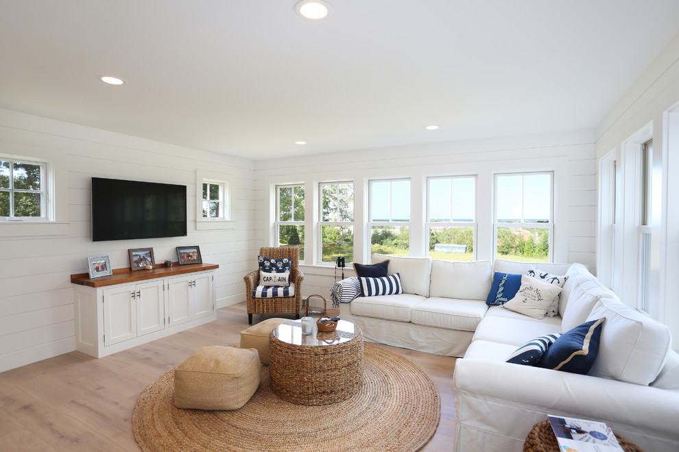 Mid-sized beach style family room in Boston with light hardwood floors, no fireplace and white floor.