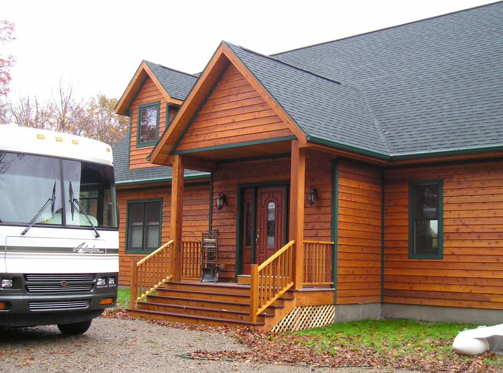 Mid-sized mountain style medium tone wood floor front door photo with a medium wood front door