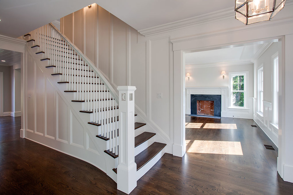 Large transitional wooden straight wood railing staircase photo with painted risers