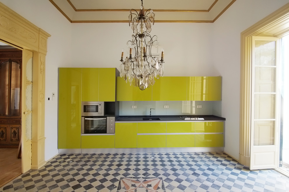 Inspiration for a mediterranean single-wall kitchen in Other with flat-panel cabinets, green cabinets and no island.