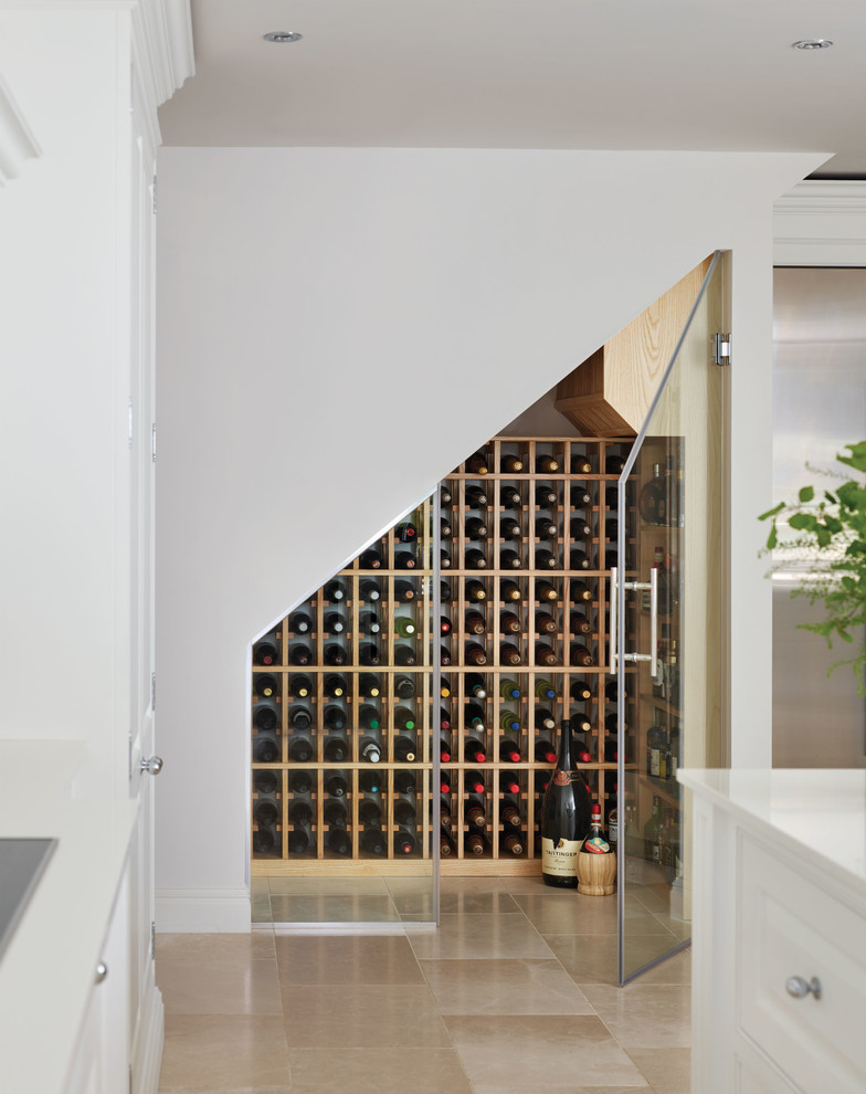 This is an example of a large contemporary wine cellar in Manchester with marble floors and beige floor.