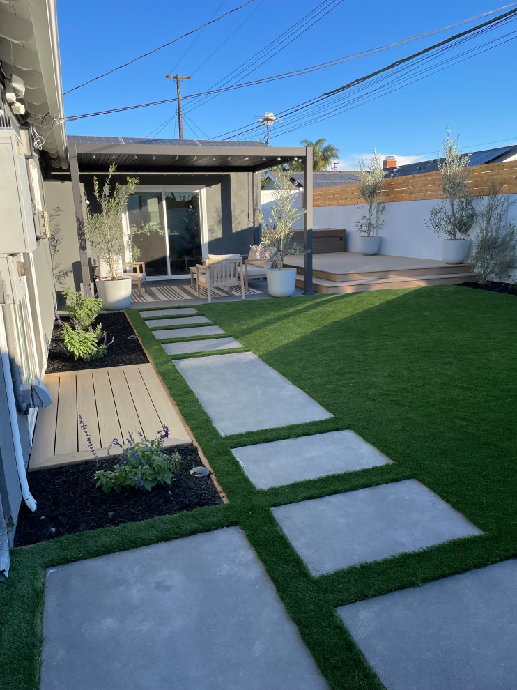 Photo of a modern back xeriscape garden in Orange County with a garden path and decking.