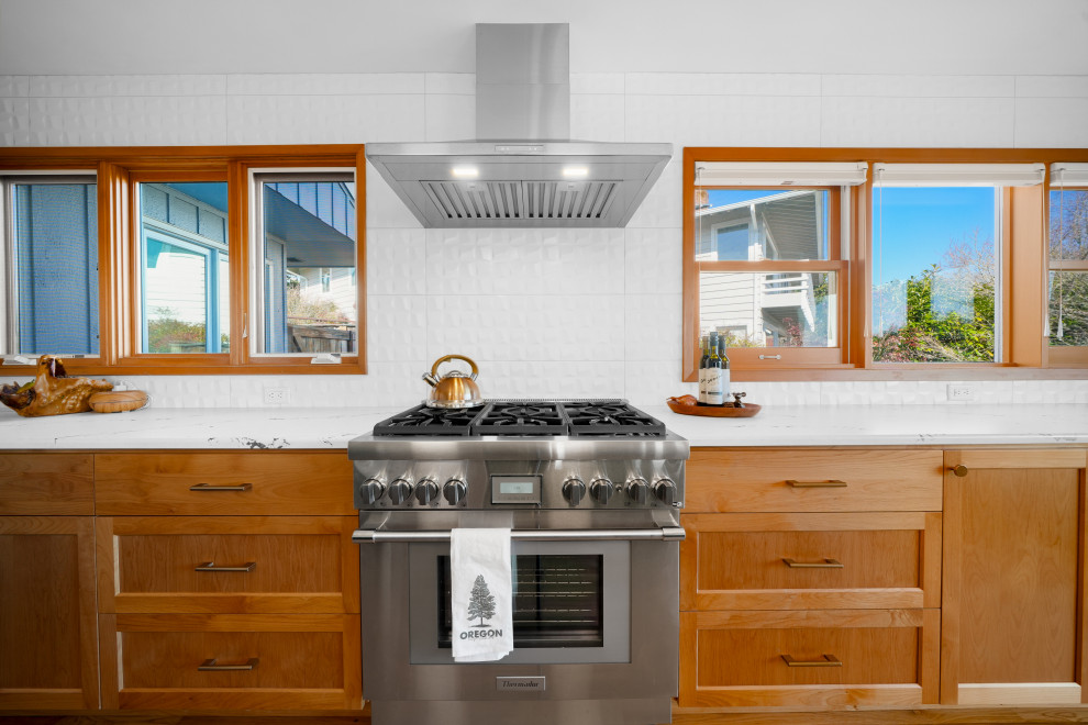 Inspiration for a transitional l-shaped medium tone wood floor kitchen remodel with shaker cabinets, white backsplash, an island and white countertops