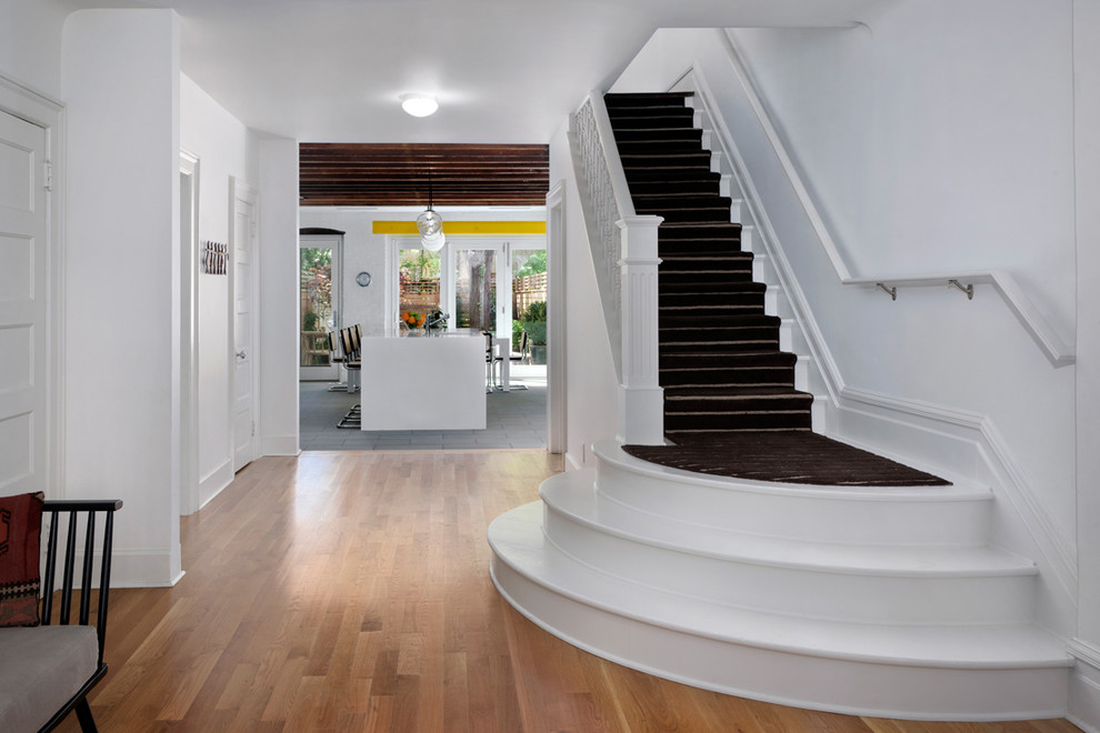 Design ideas for a large contemporary painted wood straight staircase in New York with painted wood risers.