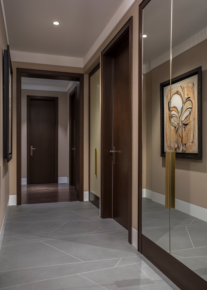 This is an example of a mid-sized transitional entry hall in Moscow with beige walls, porcelain floors and grey floor.