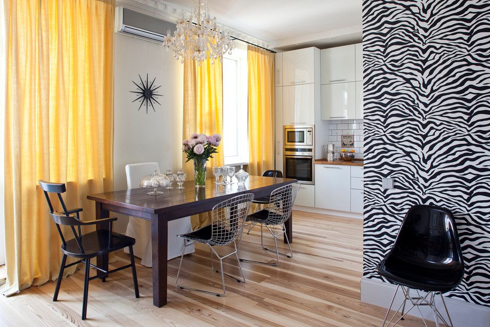 Design ideas for a contemporary dining room in Moscow with white walls and light hardwood floors.