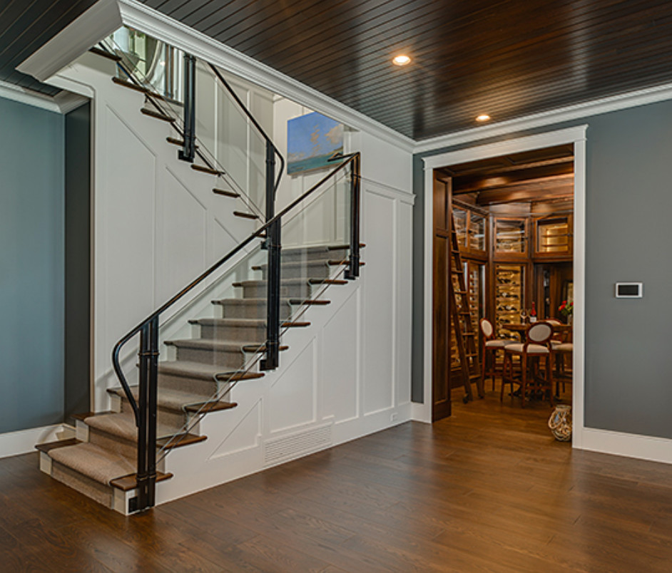 Basement - large transitional walk-out dark wood floor and brown floor basement idea with blue walls, a standard fireplace and a stone fireplace