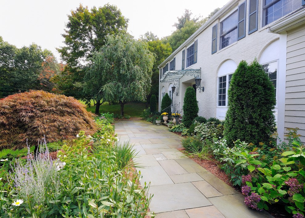 Photo of a large traditional partial sun front yard stone garden path in Other for summer.
