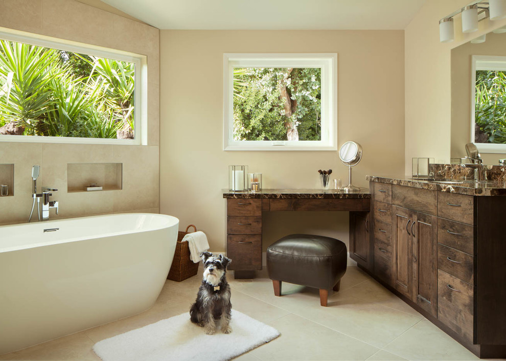 Design ideas for a large contemporary master bathroom in San Francisco with dark wood cabinets, a freestanding tub, beige tile, beige walls, flat-panel cabinets, an open shower, a two-piece toilet, stone tile, limestone floors, an undermount sink, granite benchtops, beige floor and an open shower.