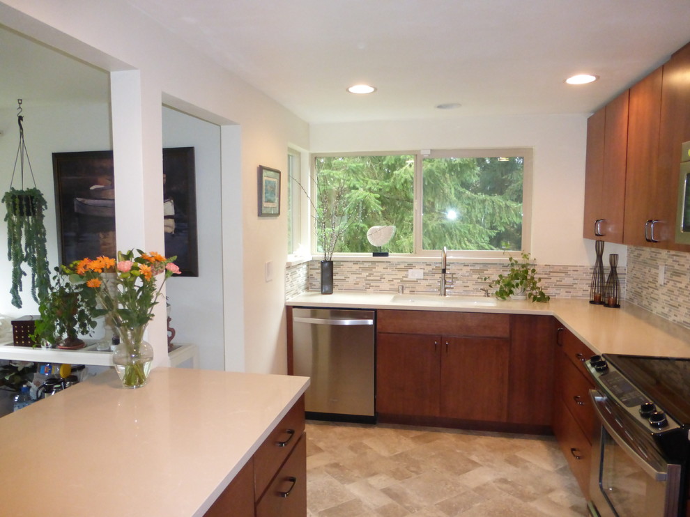 Photo of a small contemporary galley separate kitchen in Seattle with an undermount sink, flat-panel cabinets, medium wood cabinets, quartz benchtops, multi-coloured splashback, stainless steel appliances, vinyl floors and no island.