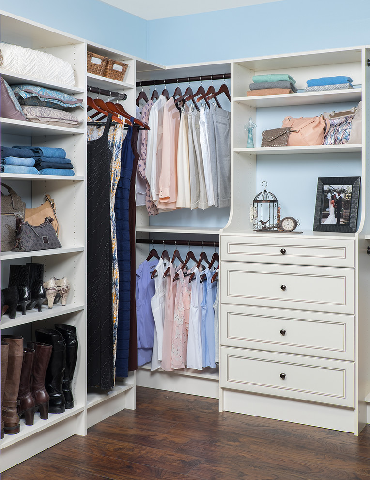 Inspiration for a mid-sized contemporary gender-neutral walk-in wardrobe in Orange County with open cabinets, white cabinets and dark hardwood floors.