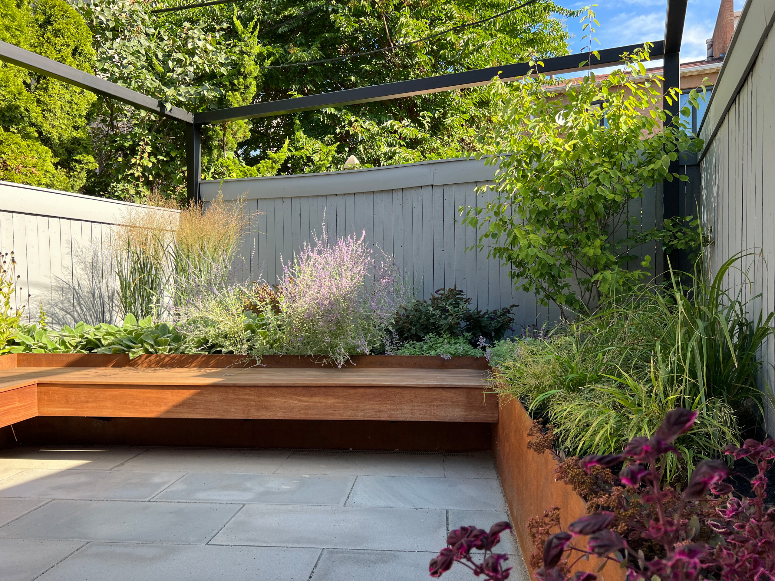 Paved patio with metal grating garden