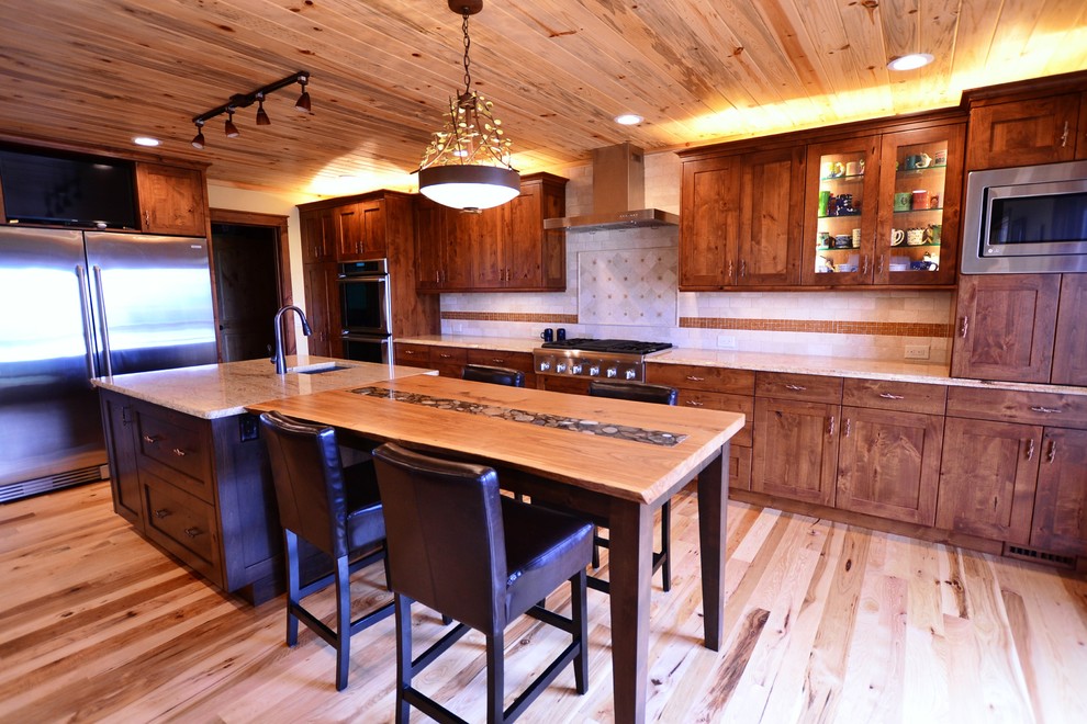 Inspiration for a large rustic u-shaped medium tone wood floor kitchen remodel with an undermount sink, flat-panel cabinets, medium tone wood cabinets, stainless steel appliances and an island