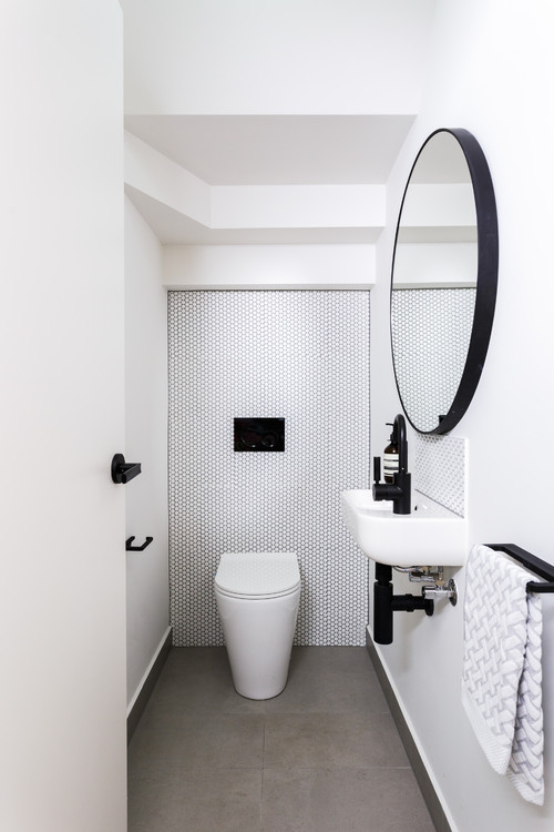 Subtle Sophistication: Small White Powder Room with Black Accents