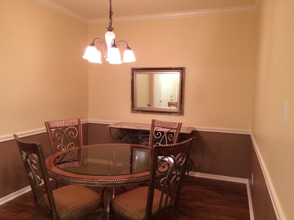 Small contemporary separate dining room in Houston with yellow walls and dark hardwood floors.